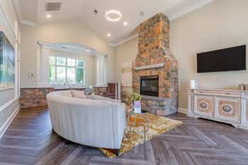 leasing office with large stone fireplace and a white couch