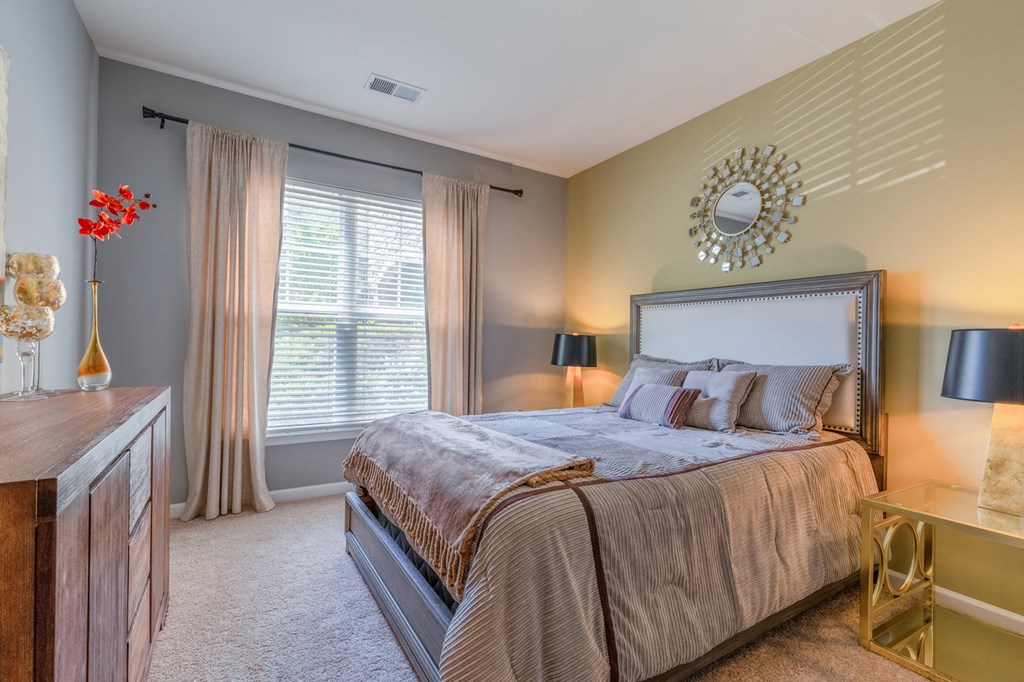 a bedroom with a large bed and a window