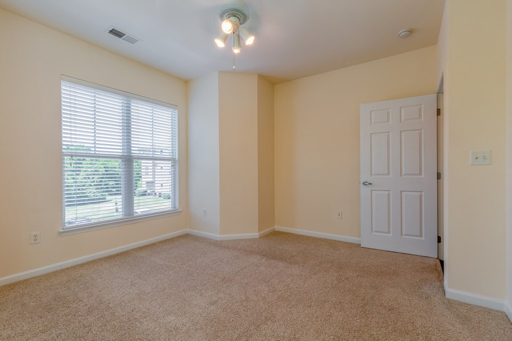 bedroom with yellow walls and large window