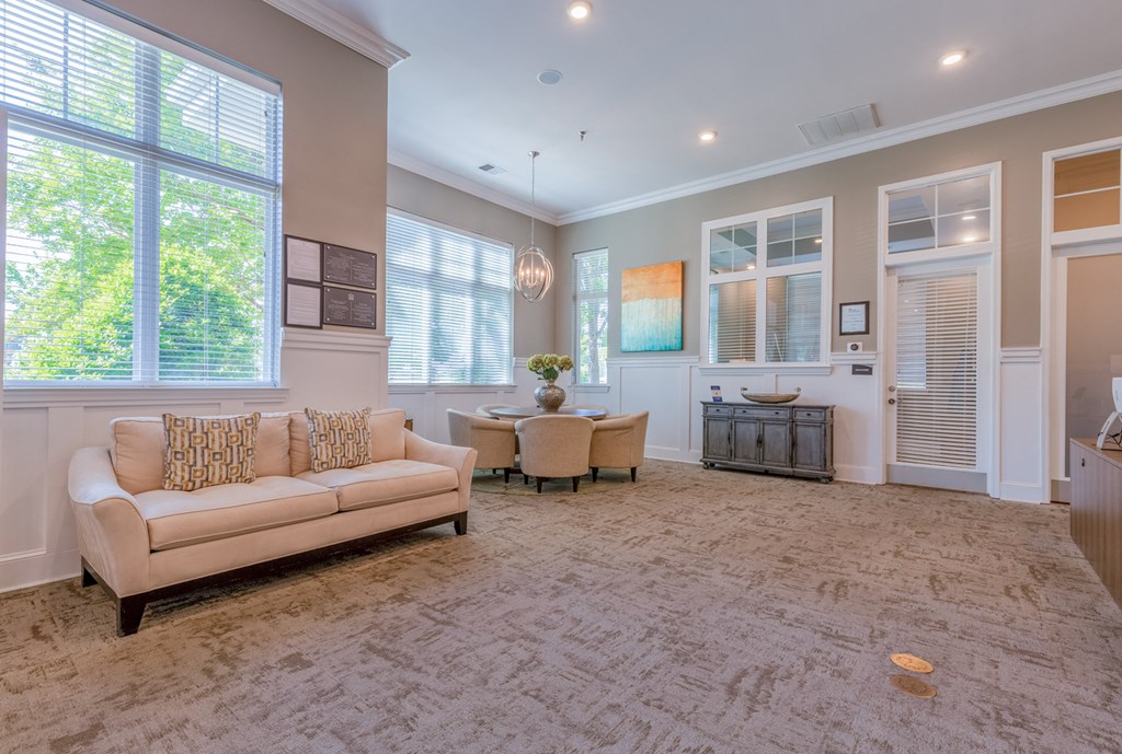clubhouse living area with a couch and chairs and a large window