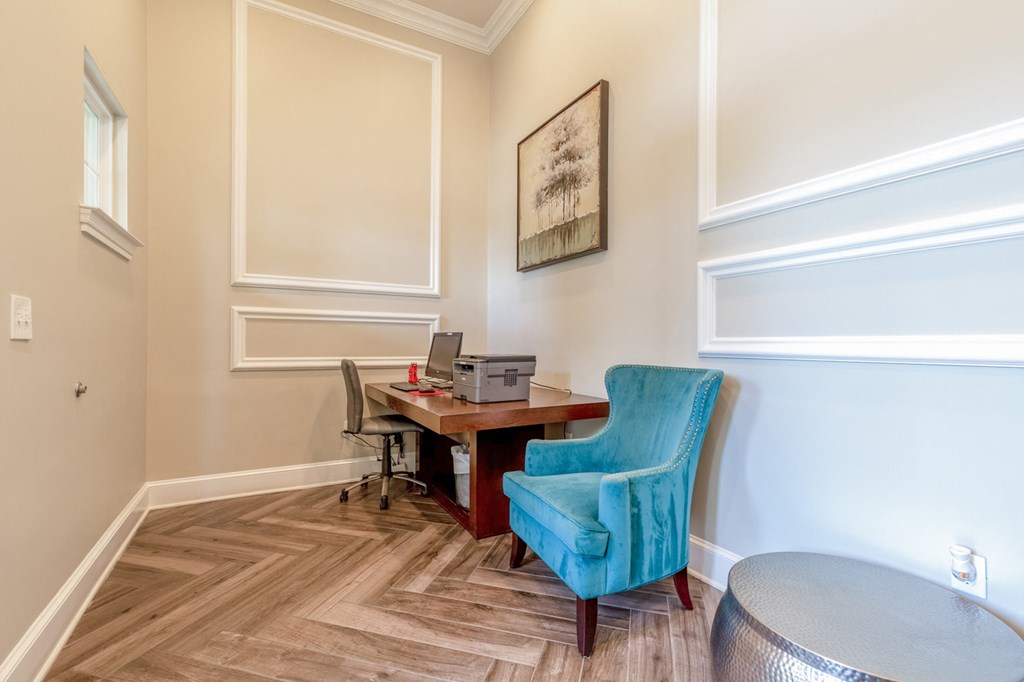 business center with a blue chair and a desk with a computer