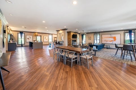 A spacious clubhouse with a wooden table and chairs.