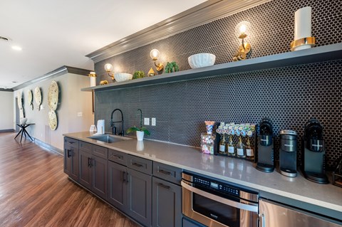 A kitchen with dark wood cabinets and a stainless steel dishwasher.