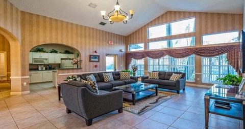 A living room with a couch, a coffee table, and a dining table.
