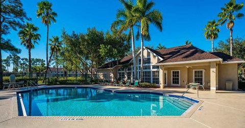 A house with a pool in front of it.