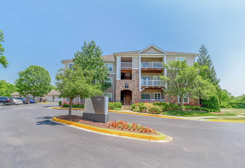 A large building with a parking lot in front of it.