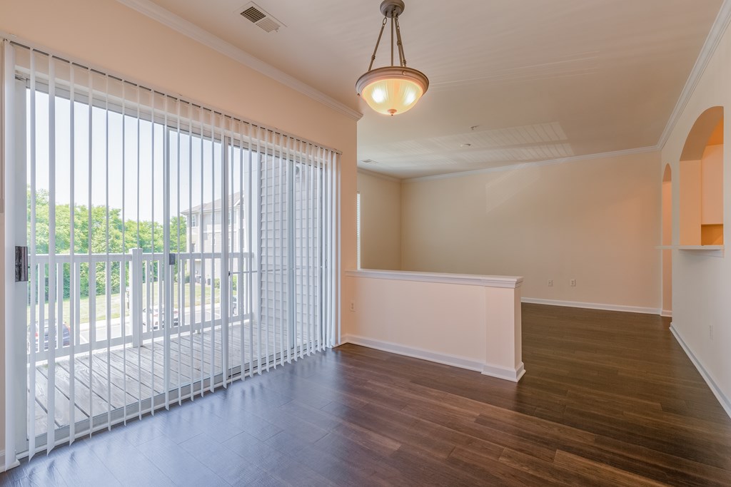 A room with a sliding door and a white bench.