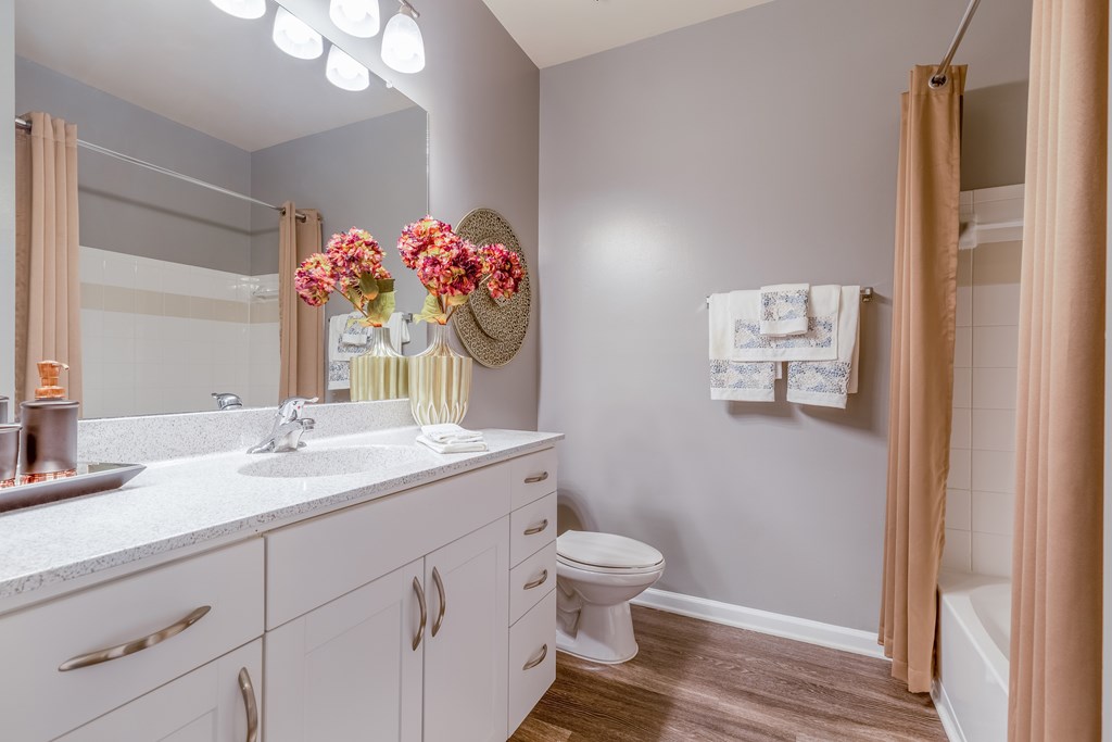 A bathroom with a white sink and a white toilet.