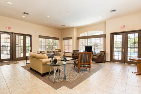 A living room with a glass table and chairs.