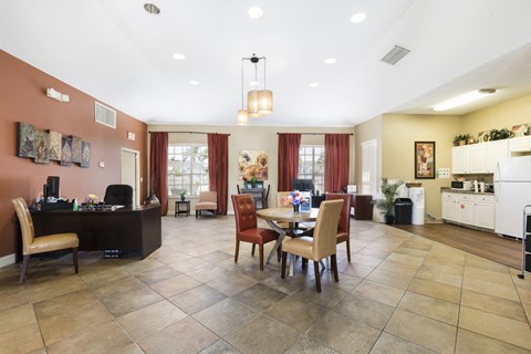 A kitchen with a table and chairs in the middle of the room.