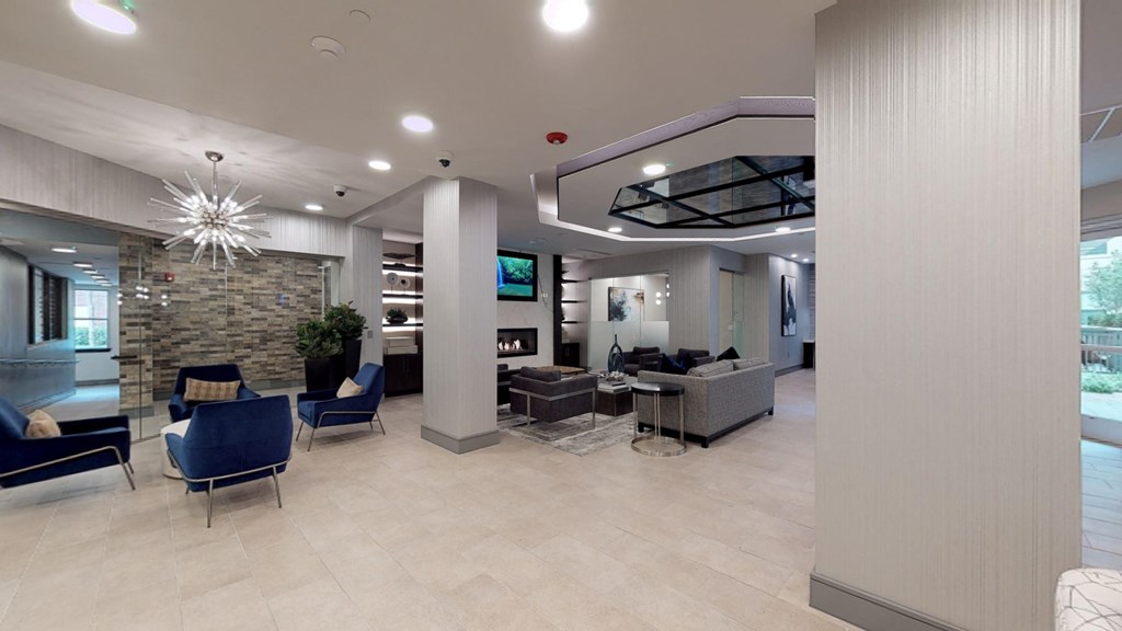 Interior of resident clubhouse facing common area with chairs and a table