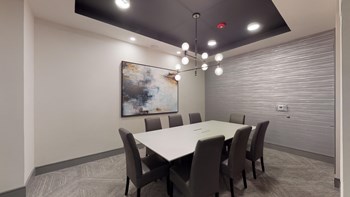 Resident conference room with a long table facing a painting - Photo Gallery 110