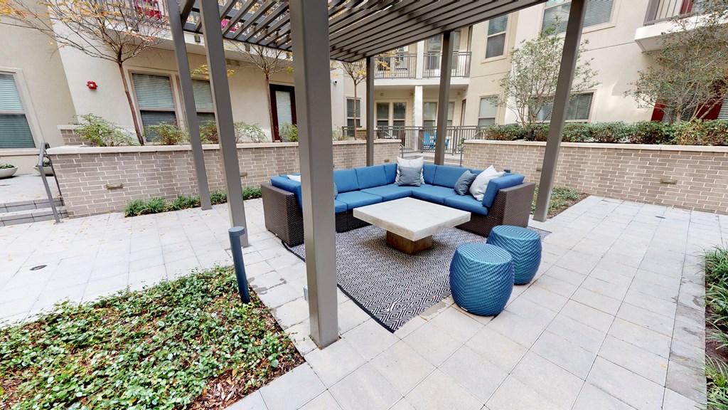 Outdoor seating area with a large couch and table