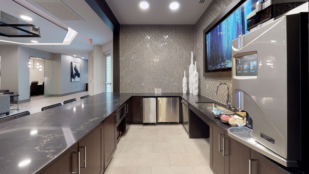 Clubhouse kitchen area with coffee machine and long bar area