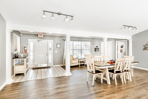 A dining room with a table set for six.