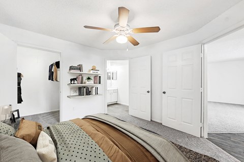 Bedroom bed facing en suite bathroom and closet