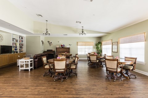 A living room with a dining table and chairs.
