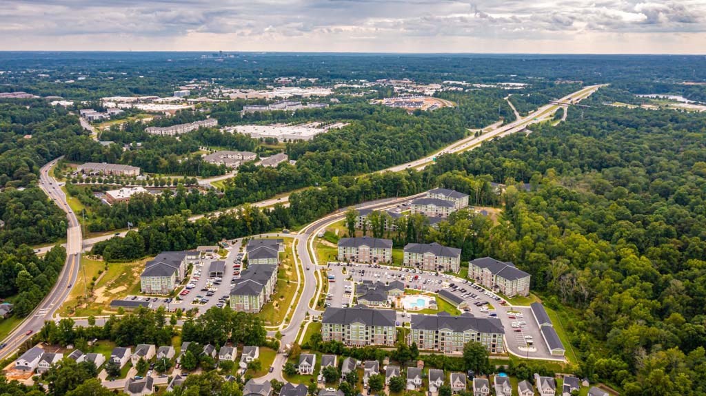 An aerial view of a large housing complex surrounded by trees. at Foxwood Apartments, Raleigh-Durham, North Carolina