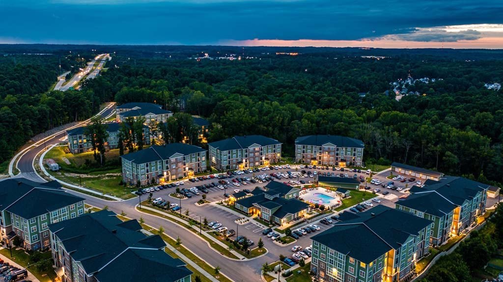 A large resort with a swimming pool and a parking lot. at Foxwood Apartments, Raleigh-Durham, NC, 27616