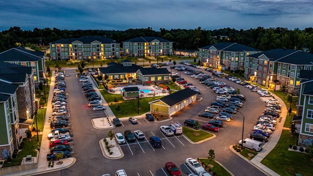 A parking lot with cars and apartment buildings in the background at Foxwood Apartments, Raleigh-Durham