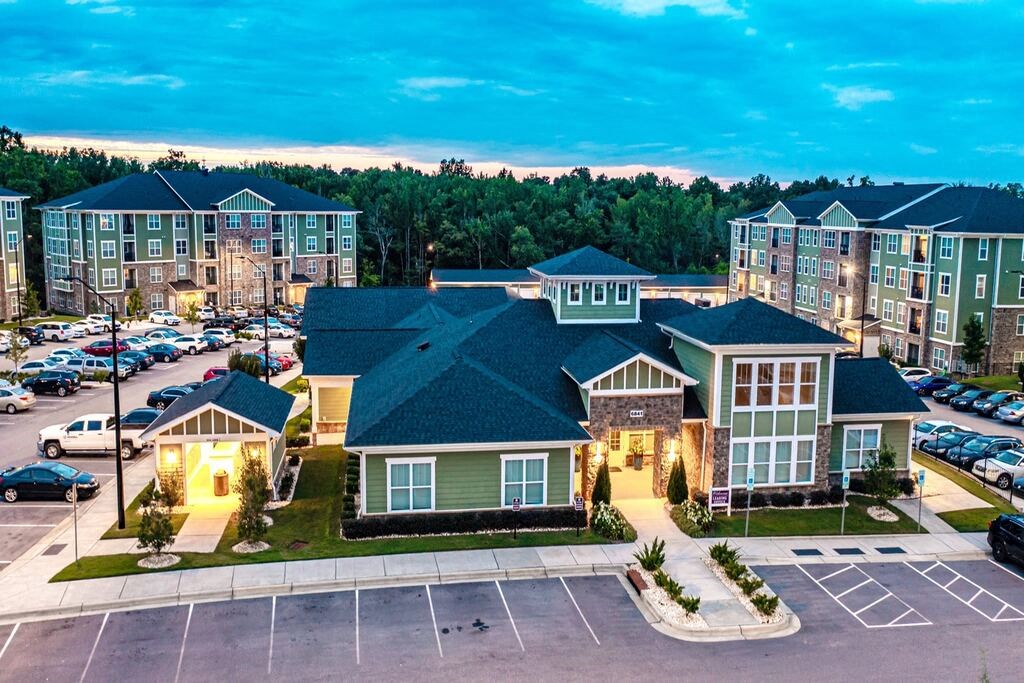 A parking lot in front of a building with a green roof at Foxwood Apartments, Raleigh-Durham, North Carolina
