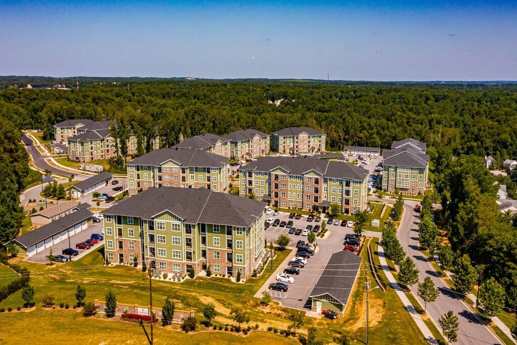 A large building complex with a parking lot in front at Foxwood Apartments, North Carolina, 27616
