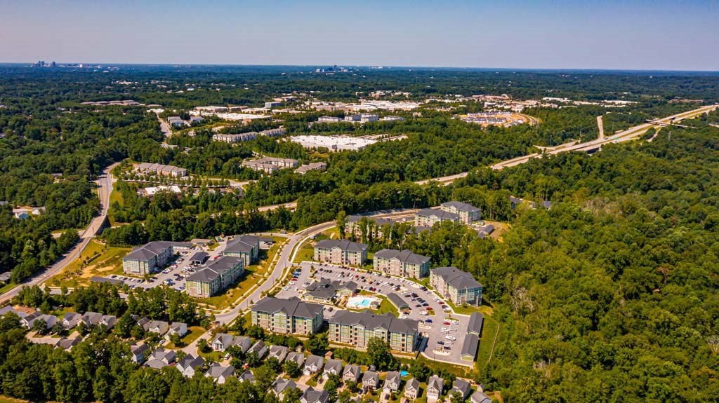 A bird's eye view of a residential area with apartment buildings and a road at Foxwood Apartments, Raleigh-Durham, North Carolina
