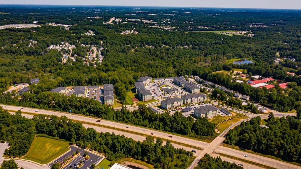 An aerial view of a suburban area with roads and buildings at Foxwood Apartments, Raleigh-Durham