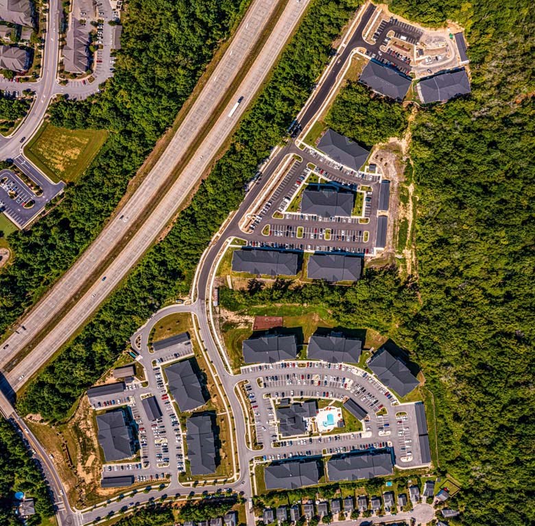 A bird's eye view of a residential area with a large building in the center at Foxwood Apartments, Raleigh-Durham