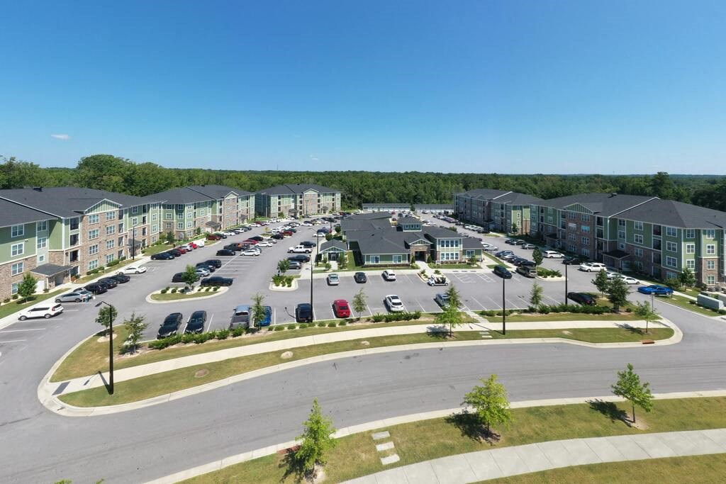 A large parking lot is surrounded by apartment buildings at Foxwood Apartments, Raleigh-Durham, NC