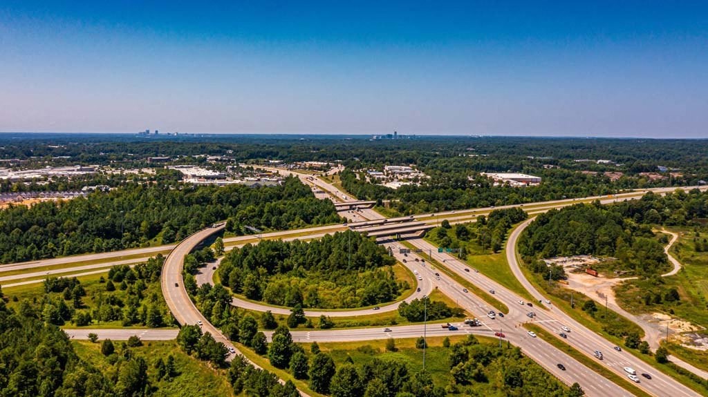 A highway interchange with multiple lanes and traffic at Foxwood Apartments, Raleigh-Durham, NC