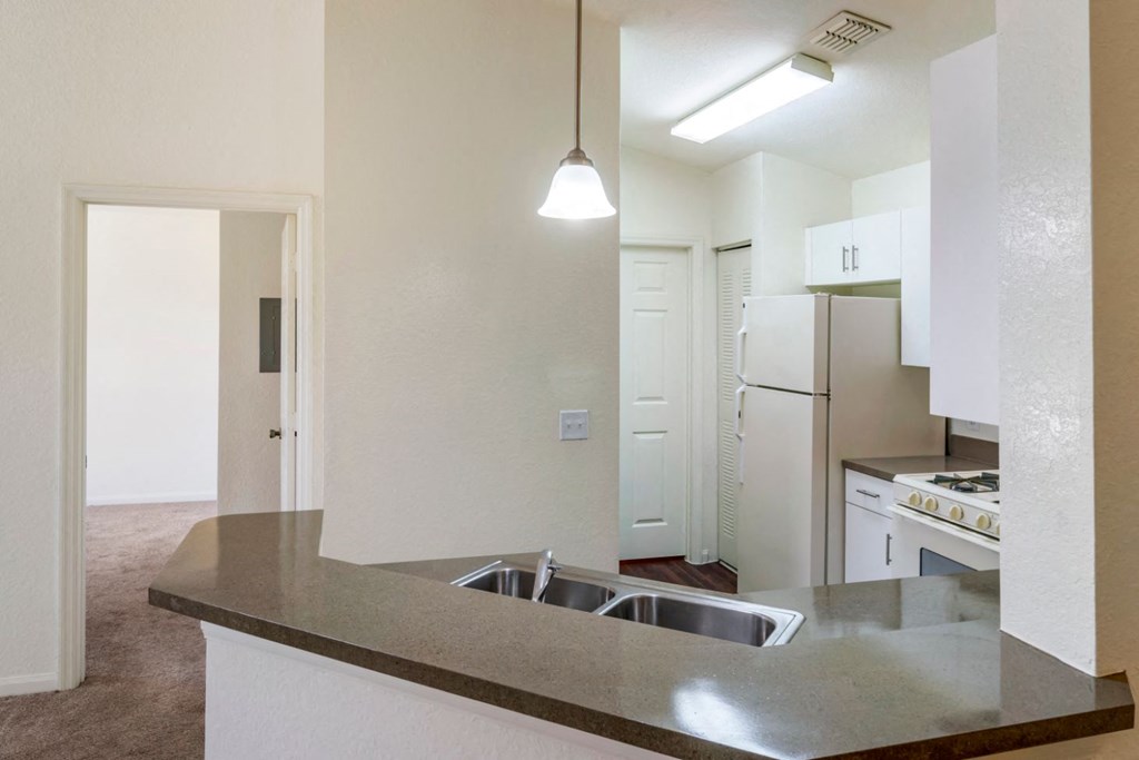 Kitchen with breakfast bar and pendant lighting