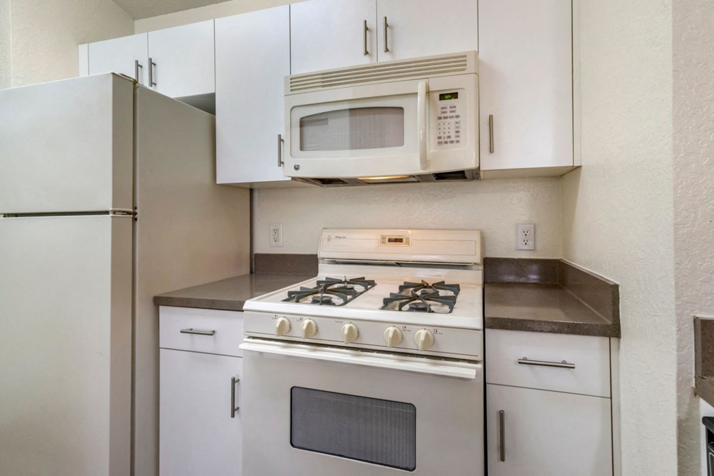 Fully equipped kitchen with white appliances and white appliances