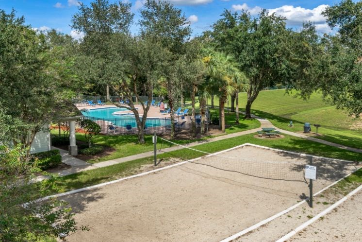 Ariel view of swimming pool and outdoor sand sand volleyball court