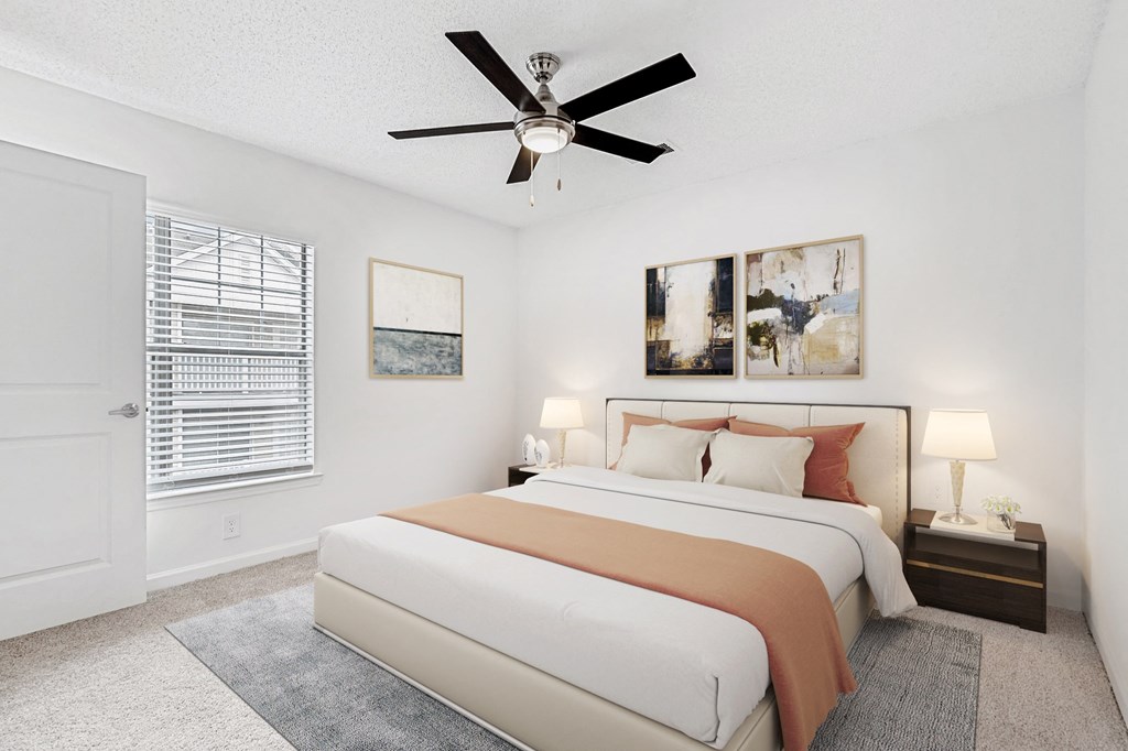 A bedroom with a large bed and a ceiling fan. at The Grayson Apartment Homes, Charlotte