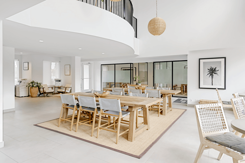 a room with a large wooden table and chairs