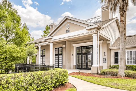 Leasing office exterior surrounded by native landscaping