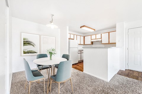 Open dining area with kitchen and modern fixtures at Riverwalk Apartments, Colorado