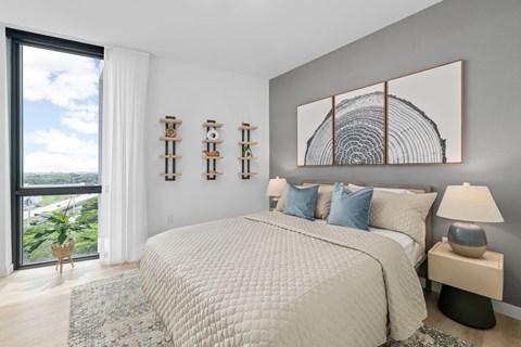 A bedroom with a large bed and a view of the ocean.