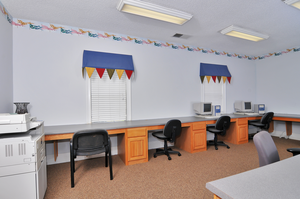 Computer lab with computers, desks, and chairs