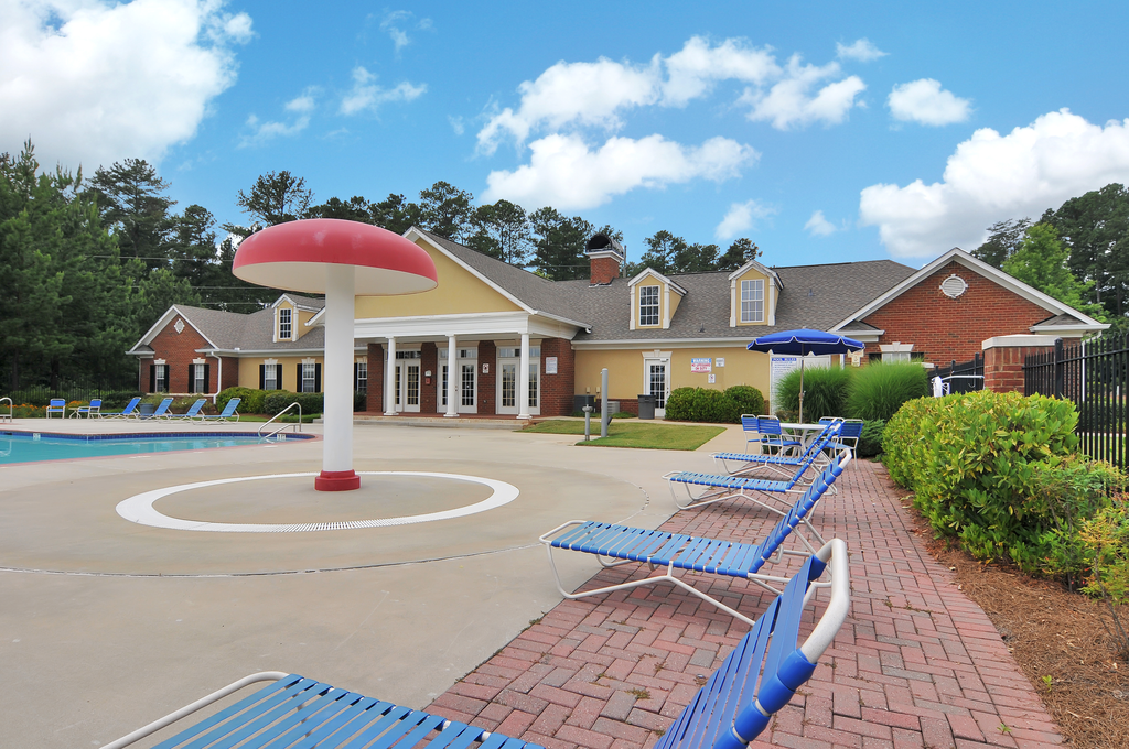 Swimming pool with lounge chairs, tanning deck.