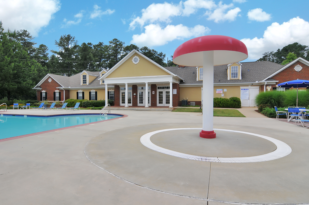 Swimming pool with lounge chairs, tanning deck.
