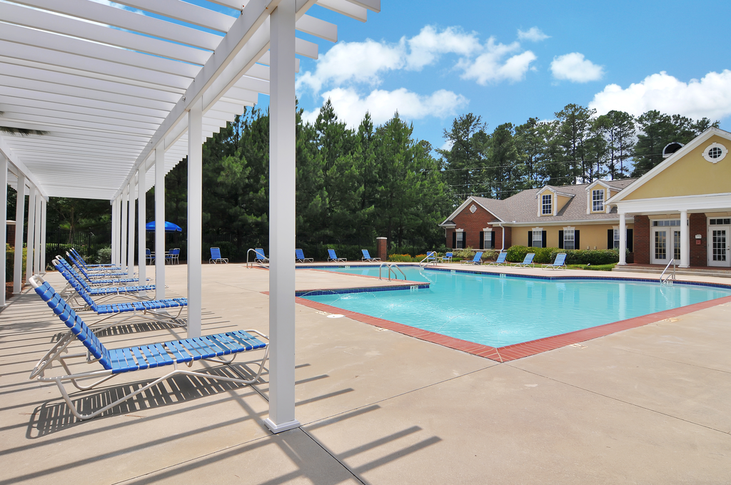 Swimming pool with lounge chairs, tanning deck.