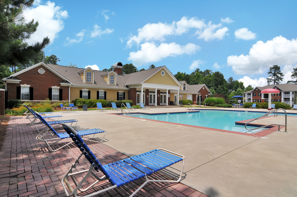 Swimming pool with lounge chairs, tanning deck.