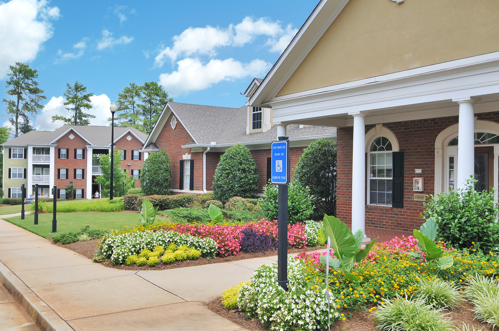 Exterior of leasing office with flower beds