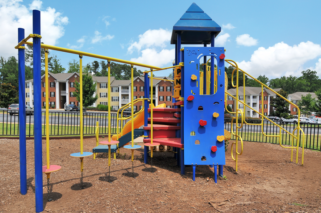 Playground with a park bench looking toward the playground equipment