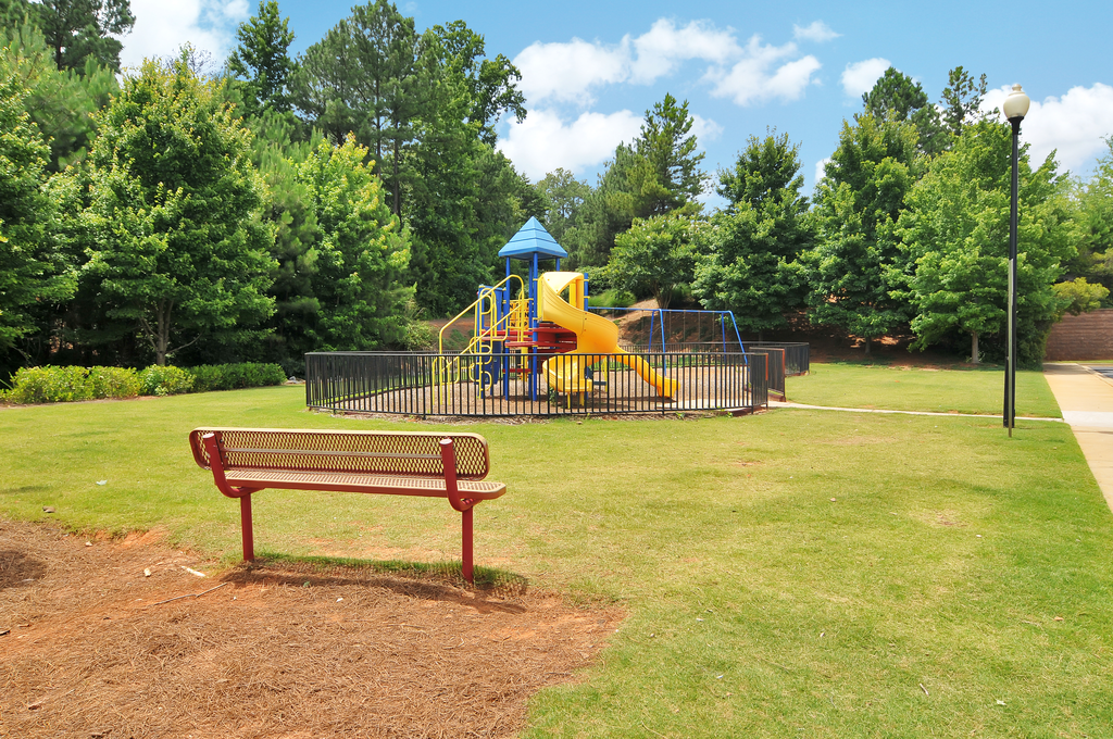 Playground with a park bench looking toward the playground equipment