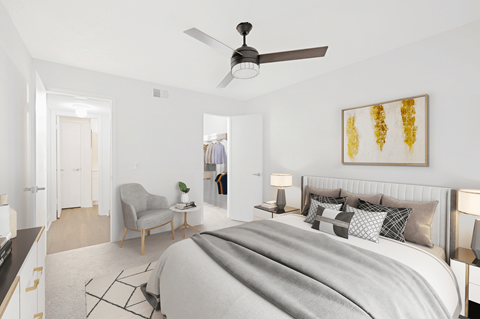 a bedroom with a large bed and a ceiling fan
