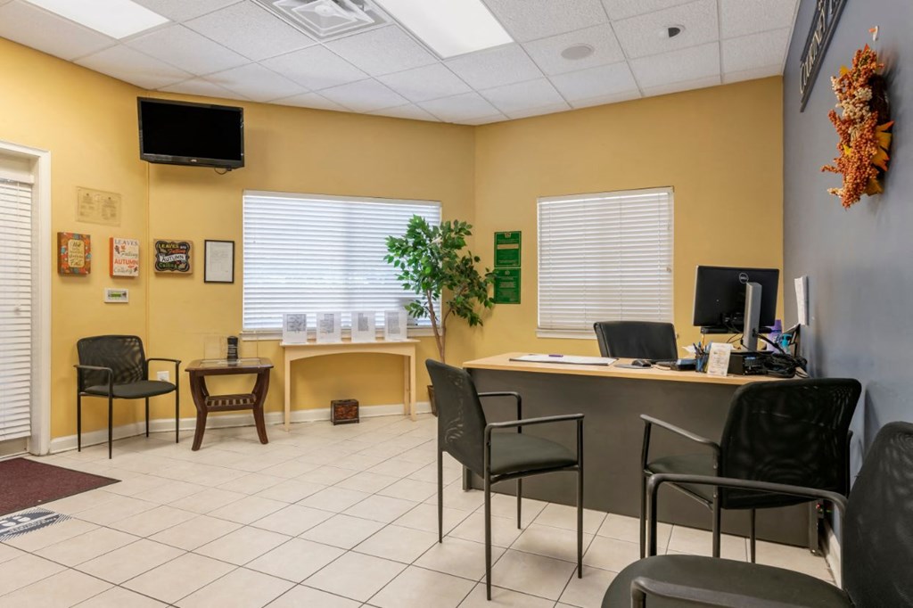 Leasing office with tiled flooring and wall mounted television