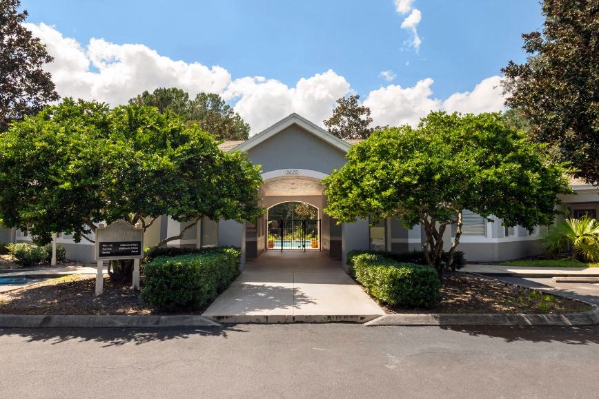 Leasing office exterior surrounded by native landscaping